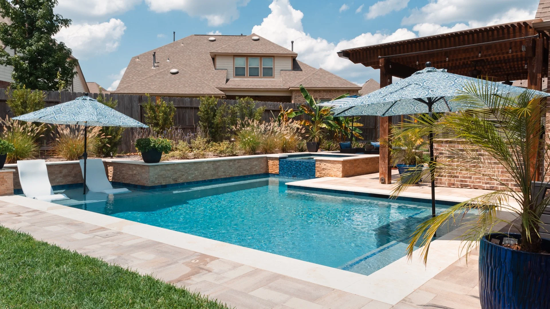 Stunning swimming pool with fountains and landscaping all around it in Overland Park, KS.
