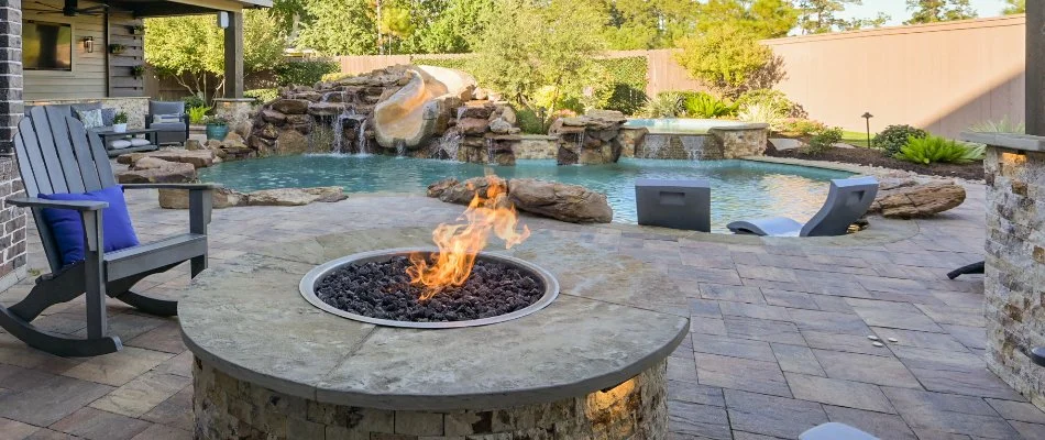 Fire pit and a pool with slide in The Woodlands, TX.