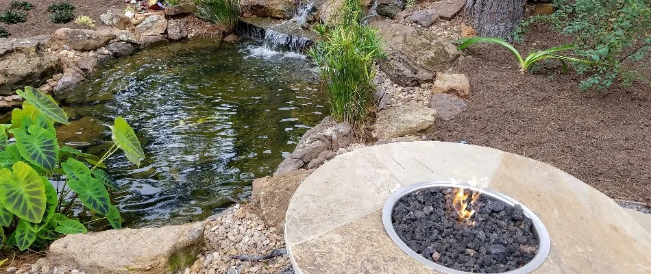 Fire pit next to a water feature in New Caney, TX.