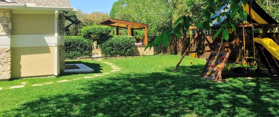 Lawn in New Caney, TX, with play area.