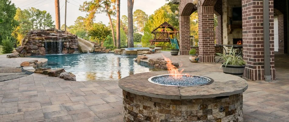 Patio area in Kingwood, TX, with a pool and fire pit.