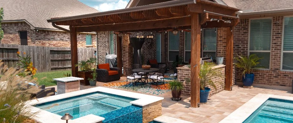 Pergola beside a pool in The Village of Grogan's Mill, TX.