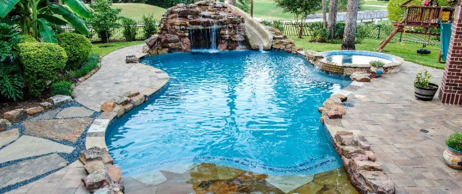 Resort-style pool in Kingwood, TX, with a waterfall and spa.
